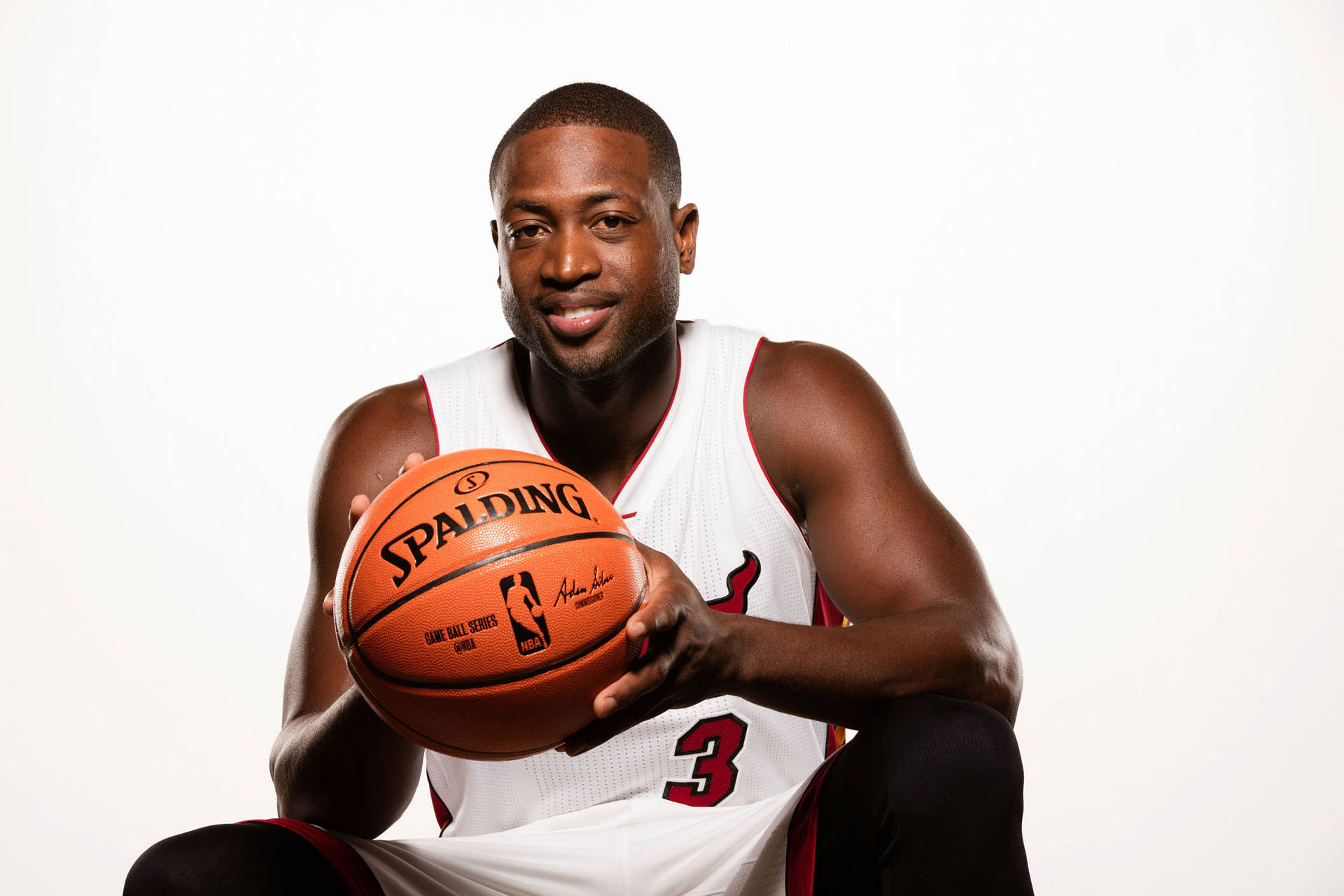 Smiling Dwyane Wade Holding Basketball Background