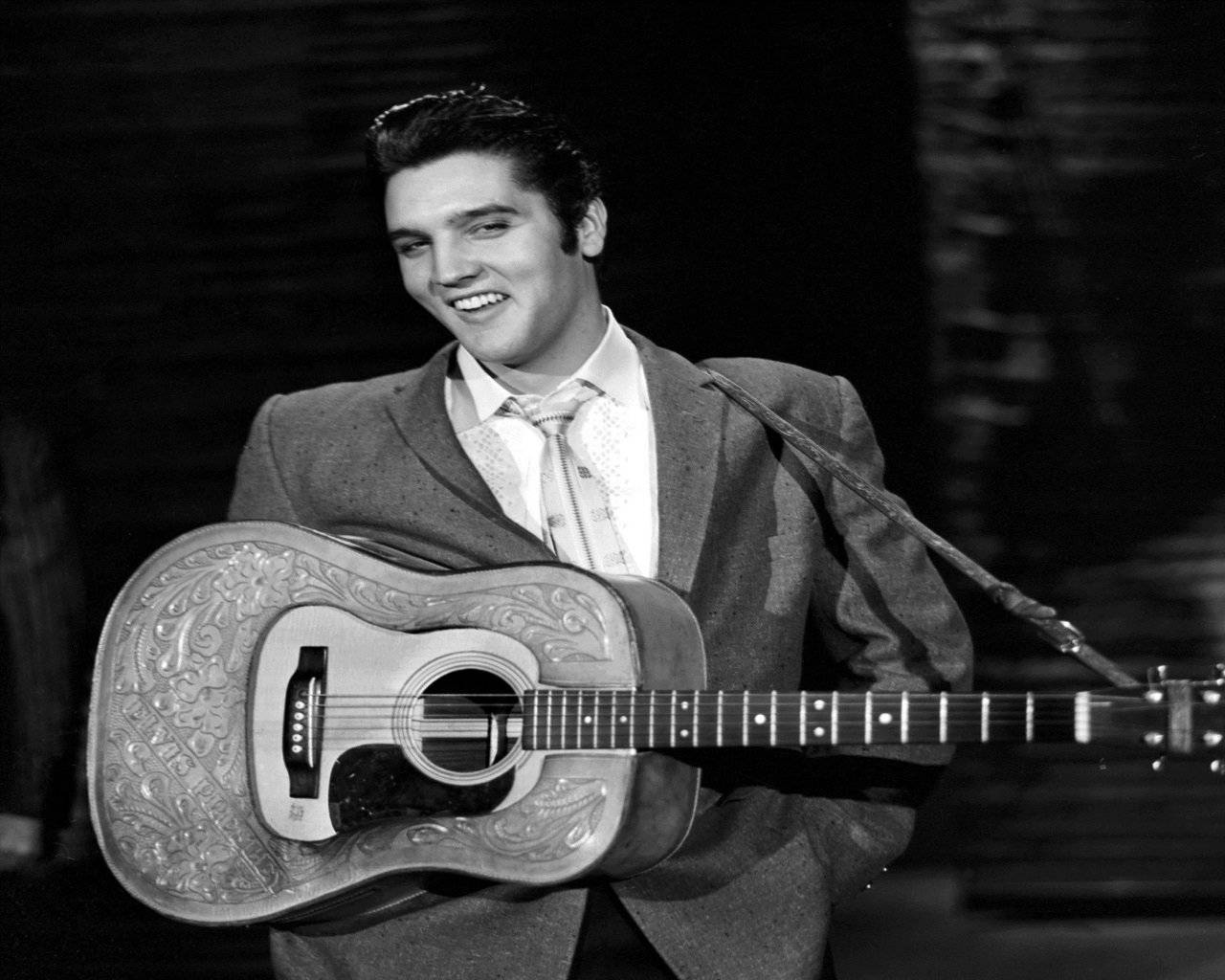 Smiling Elvis Presley With Guitar Background