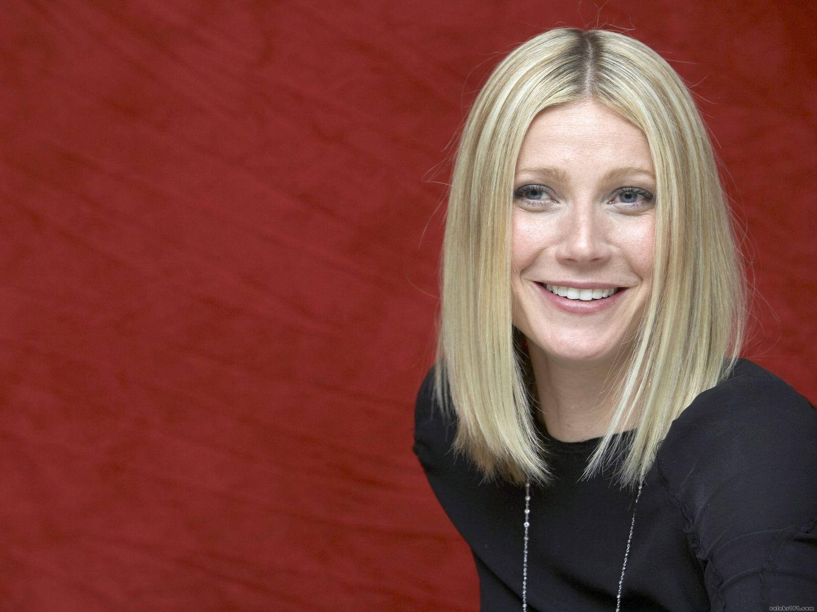 Smiling Hollywood Actress Gwyneth Paltrow Red Background