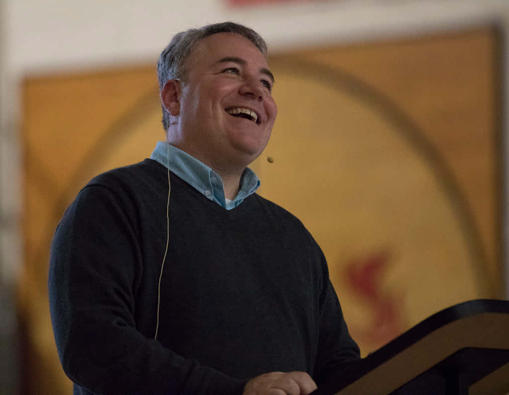Smiling Jim Mcdermott Wearing Sweater Background