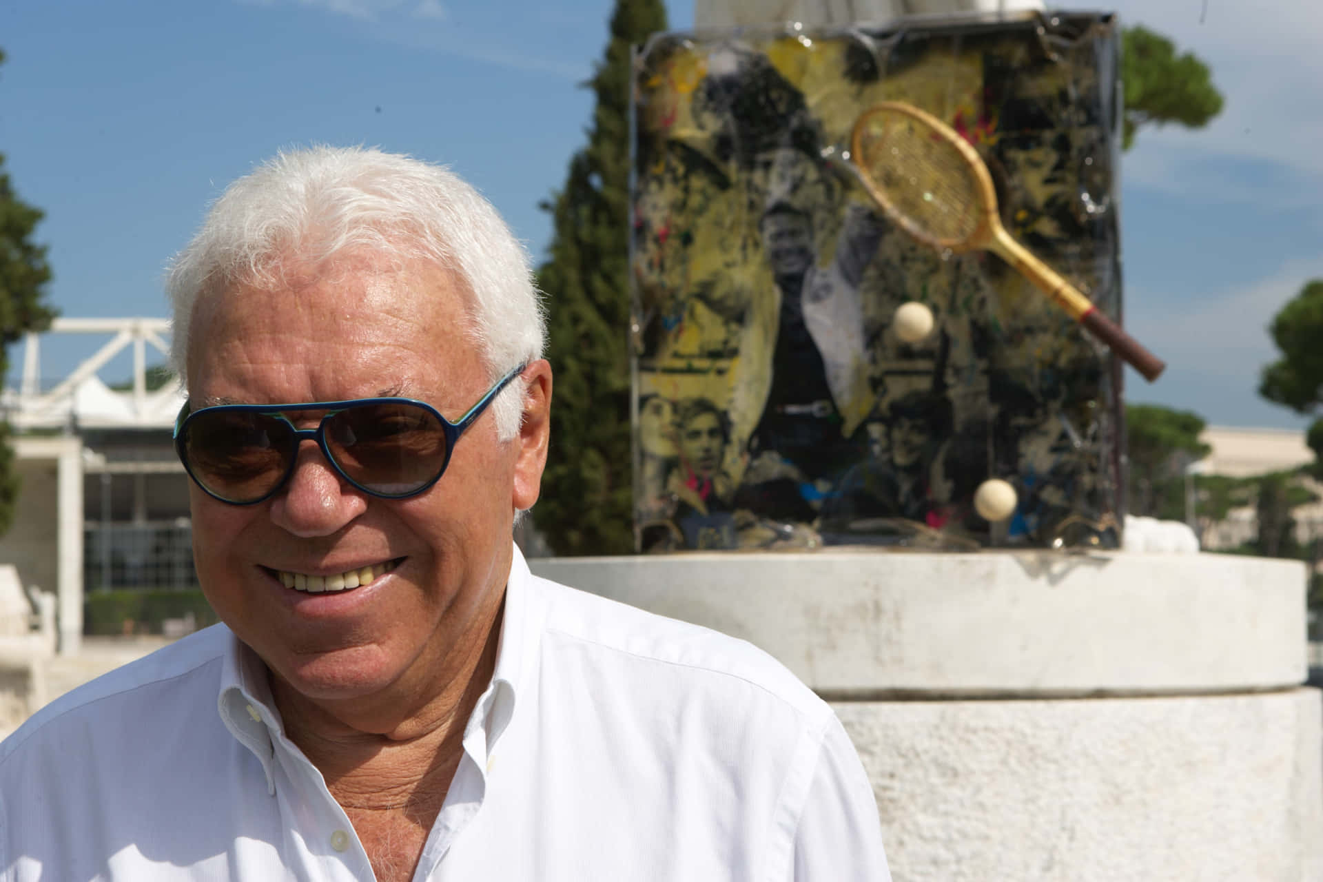 Smiling_ Man_with_ Sunglasses_and_ Tennis_ Memorabilia_ Background Background