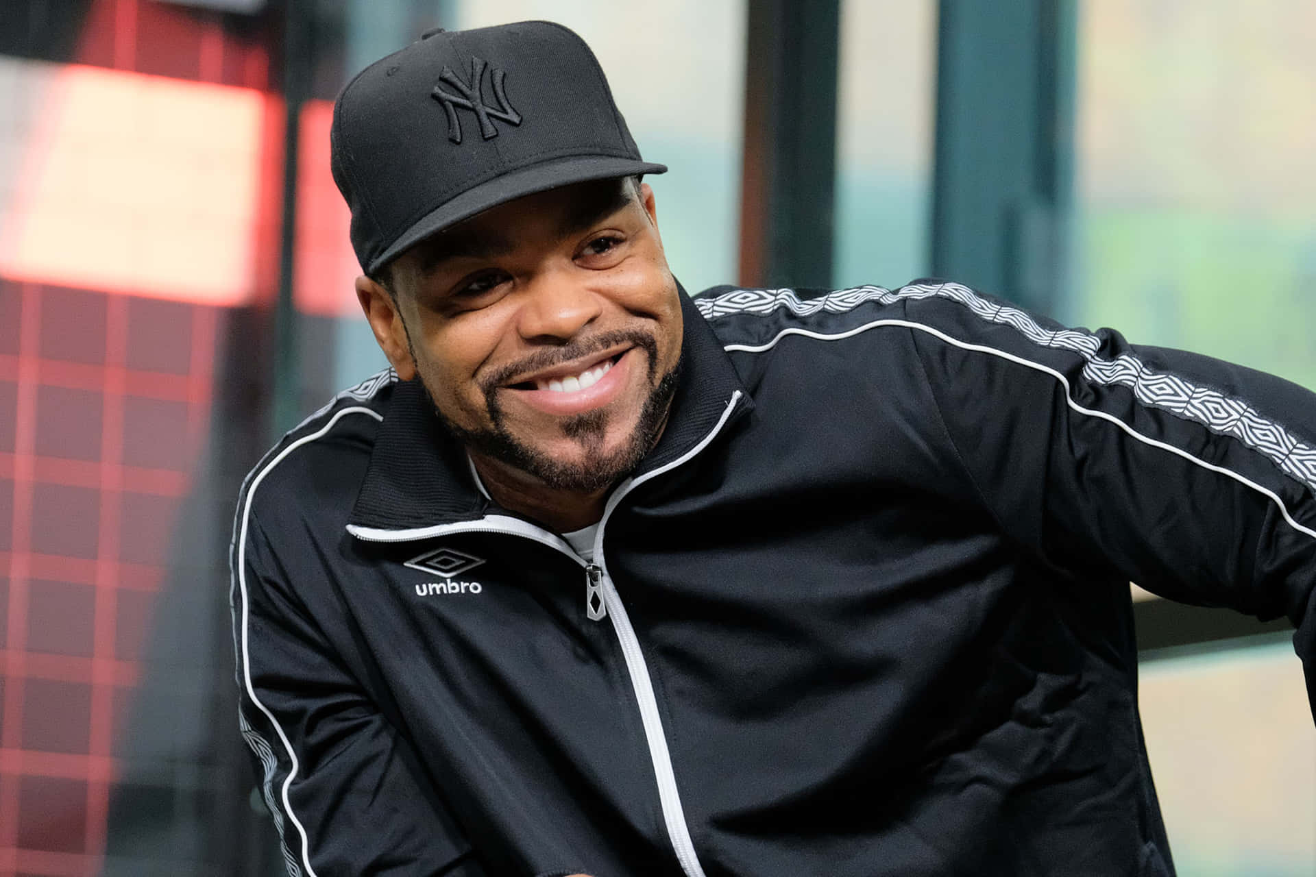 Smiling Manin Black Umbro Jacketand Yankees Cap