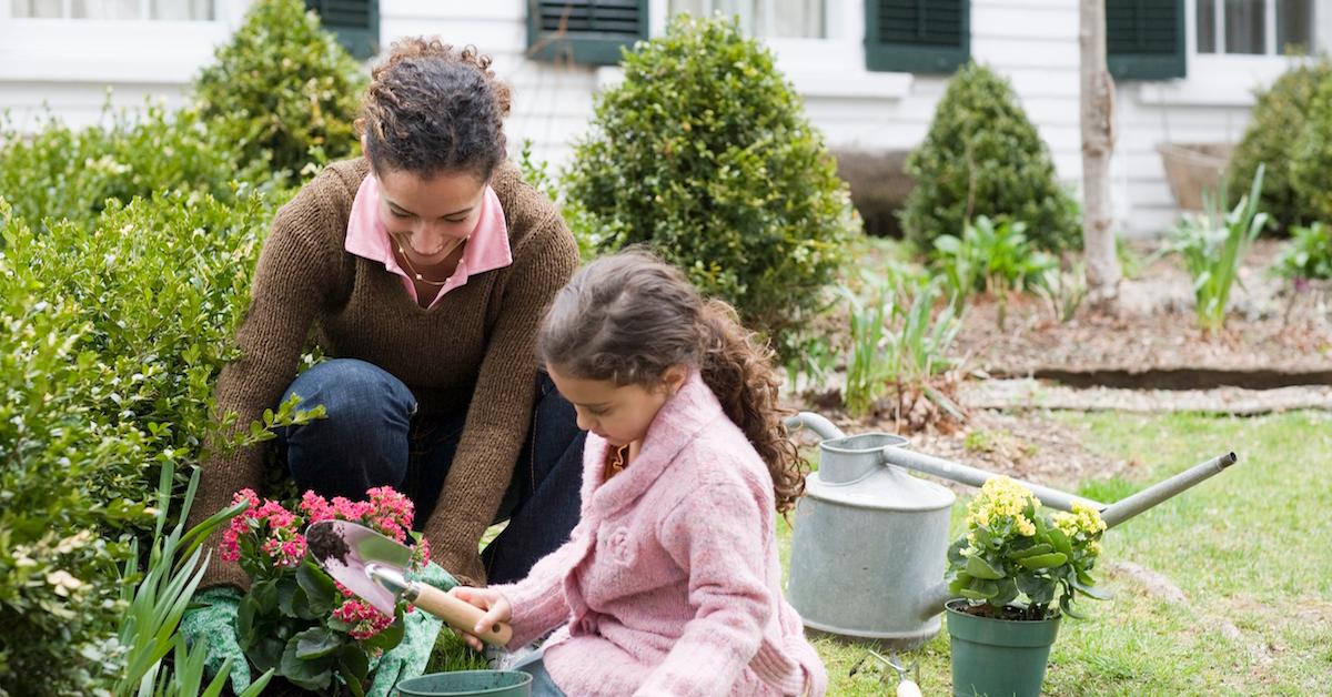 Smiling Mother And Daughter Gardening Background