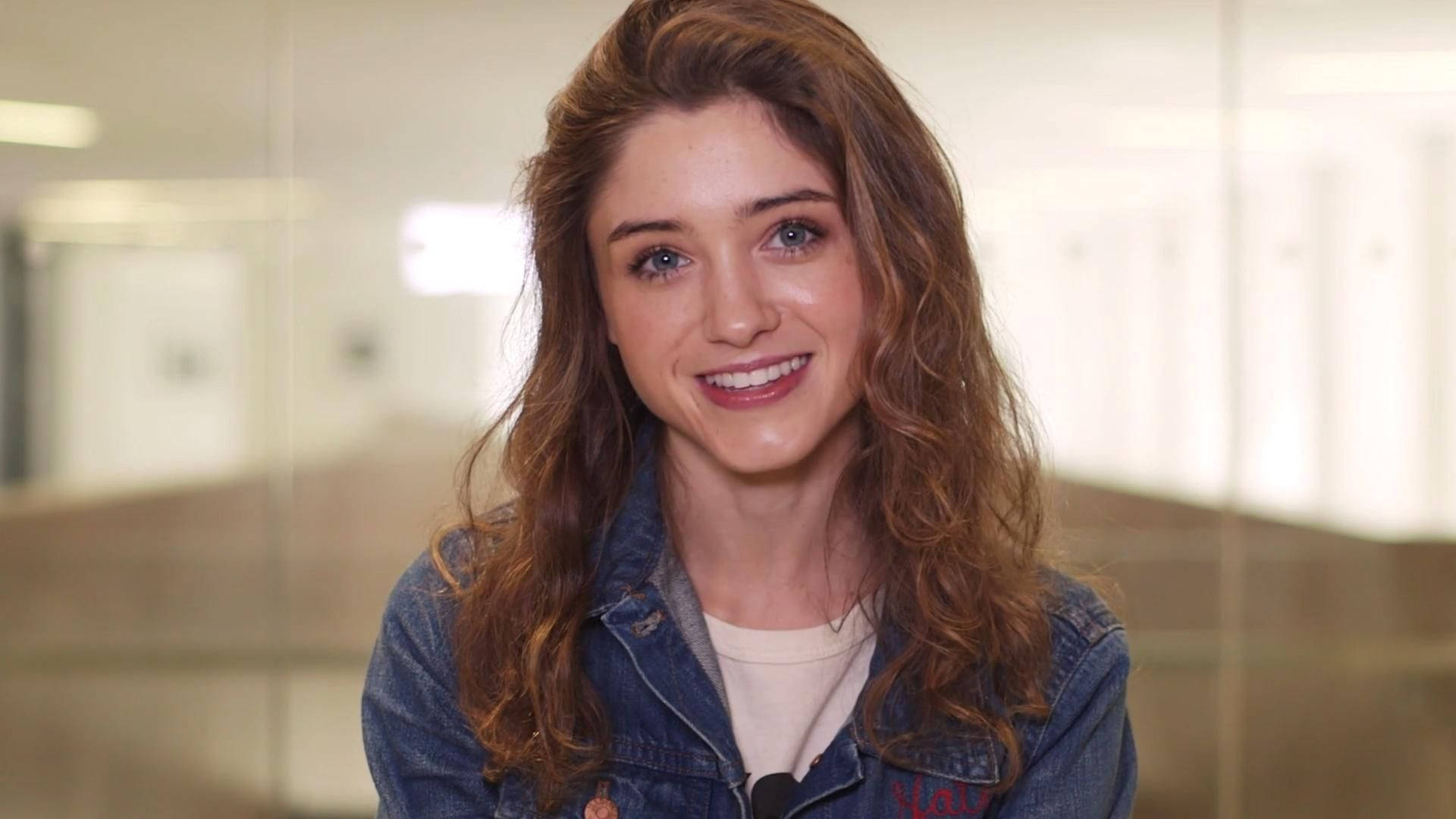 Smiling Natalia Dyer Background