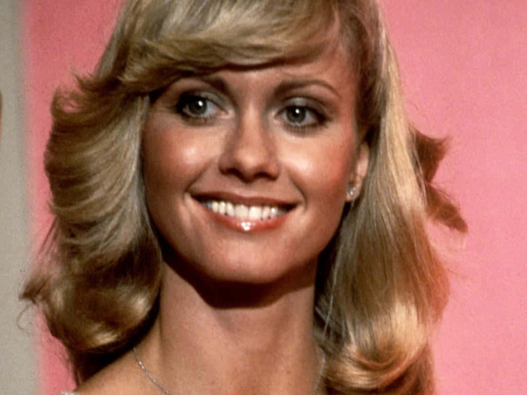 Smiling Portrait Of Olivia Newton John Background
