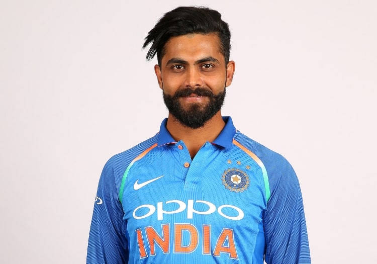 Smiling Ravindra Jadeja In Blue Unifrom Background