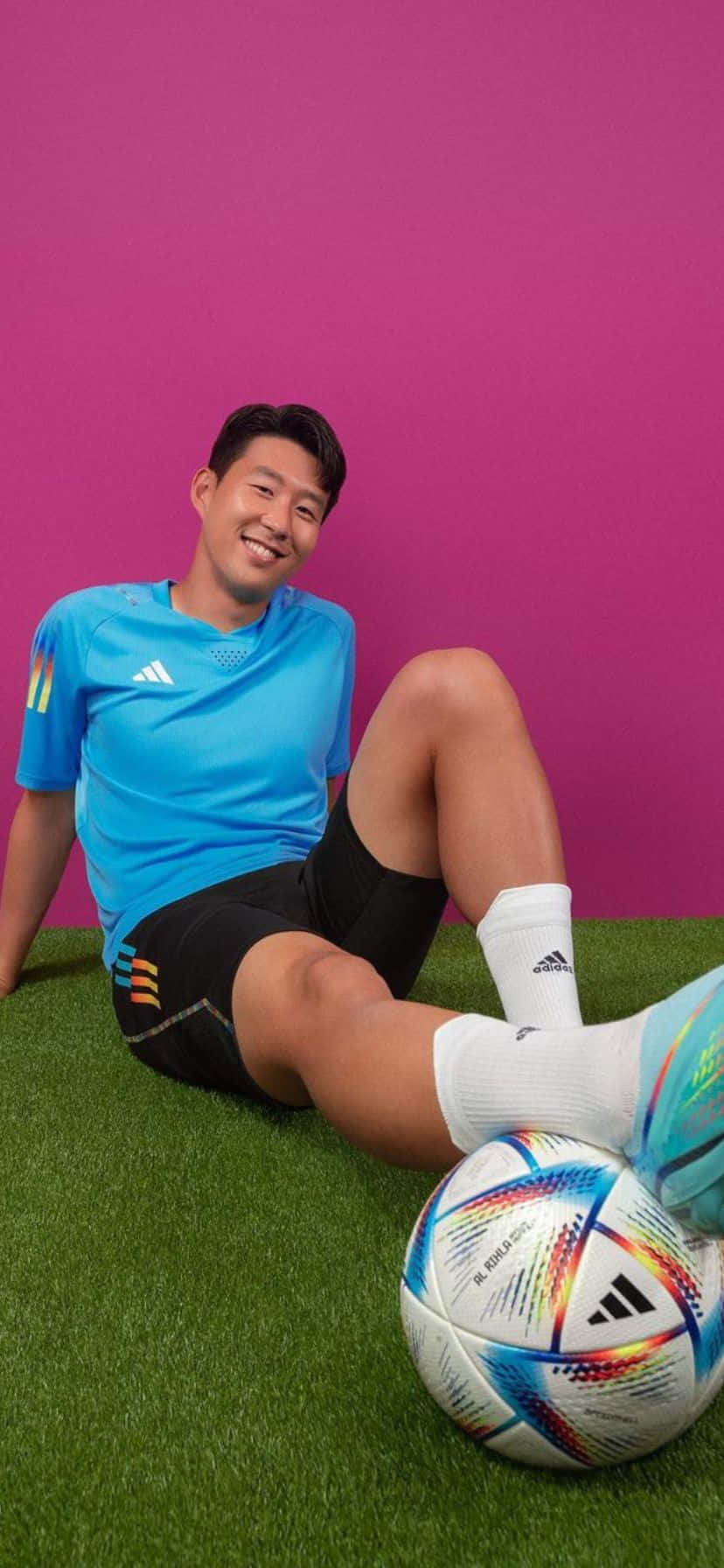 Smiling Soccer Player Sitting On Grass