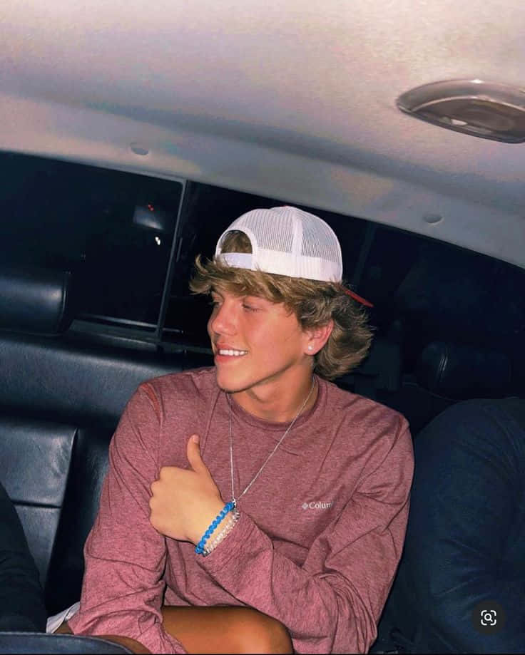 Smiling Teen Boyin Car Wearing Cap