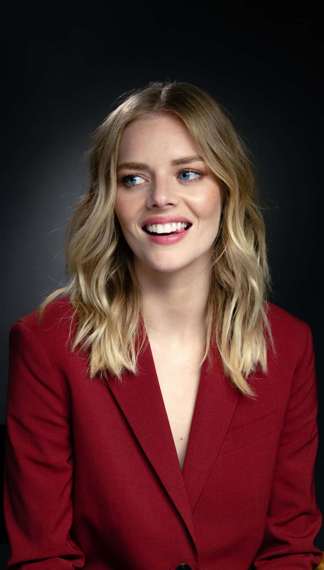Smiling Womanin Red Blazer Background