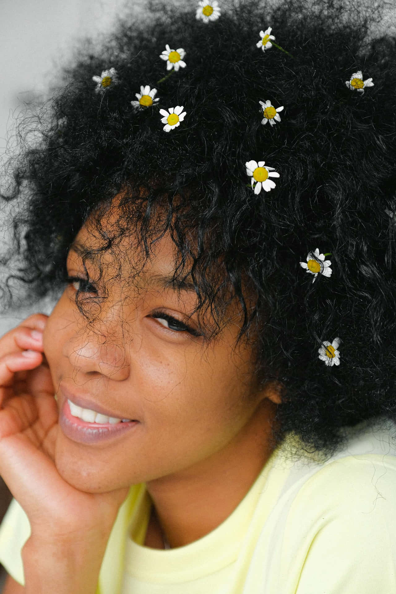 Smiling Womanwith Daisiesin Hair Background