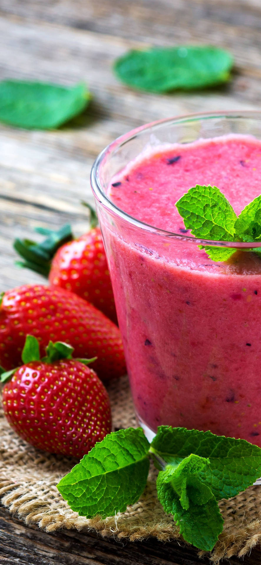 Smoothie With Strawberry And Leaf Background