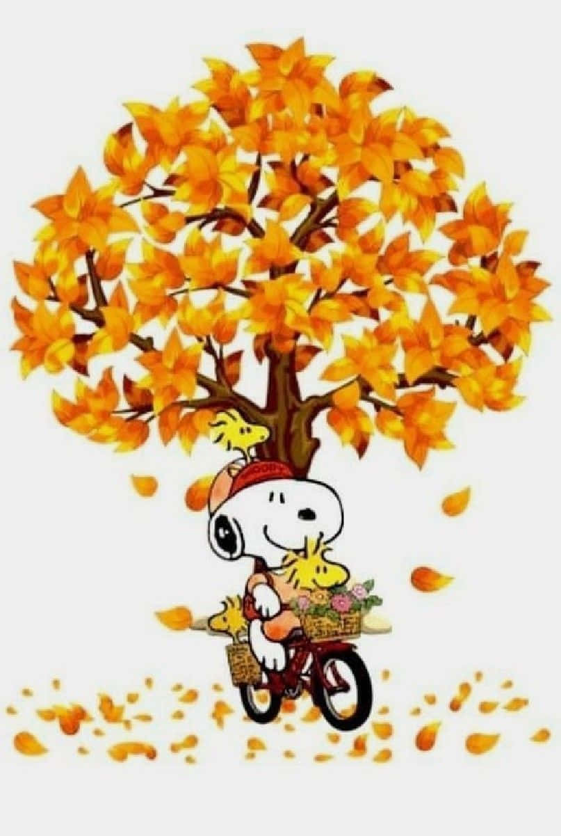 Snoopy Falls Delightedly Into A Pile Of Yellow Leaves Background