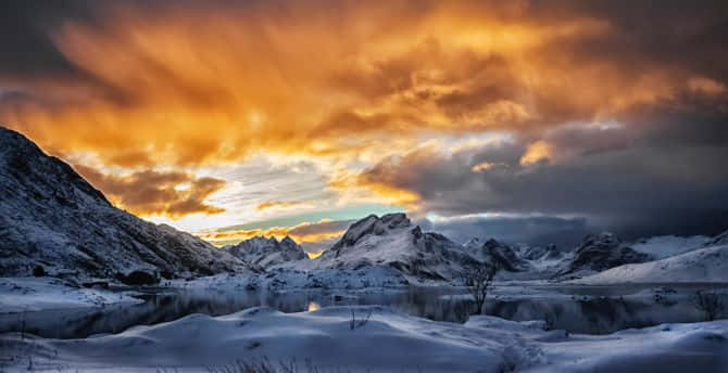 Snow Covered Mountains Sunset Under Cloudy Sky Background