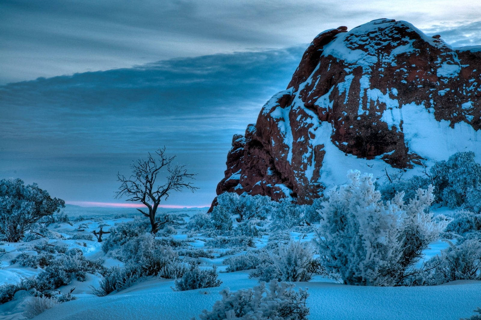 Snow-covered Rock At Arches National Park Background