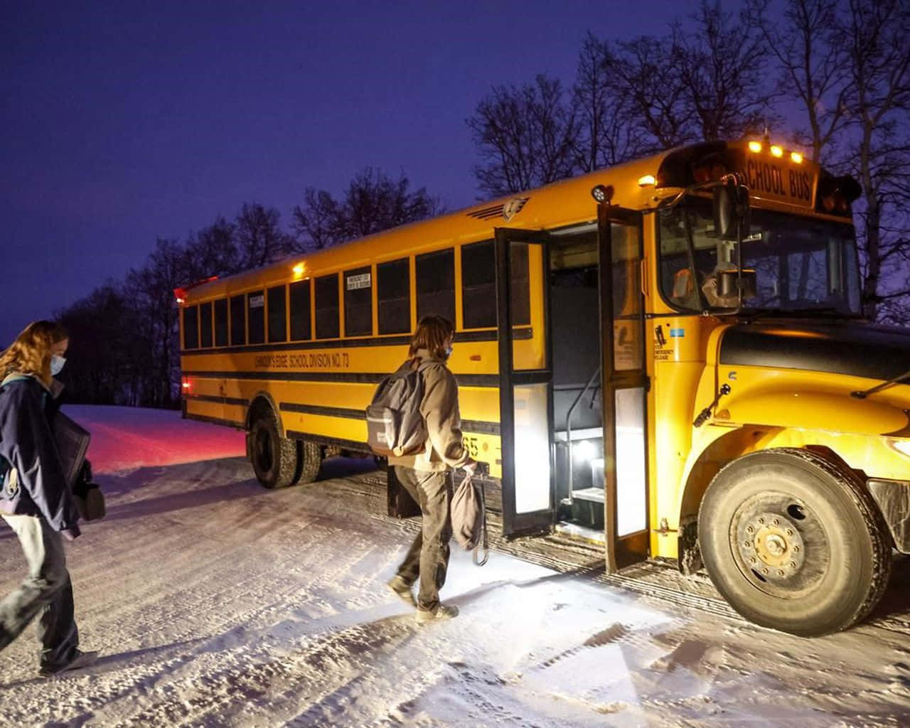 Snow-covered School Bus At A Winter Stop