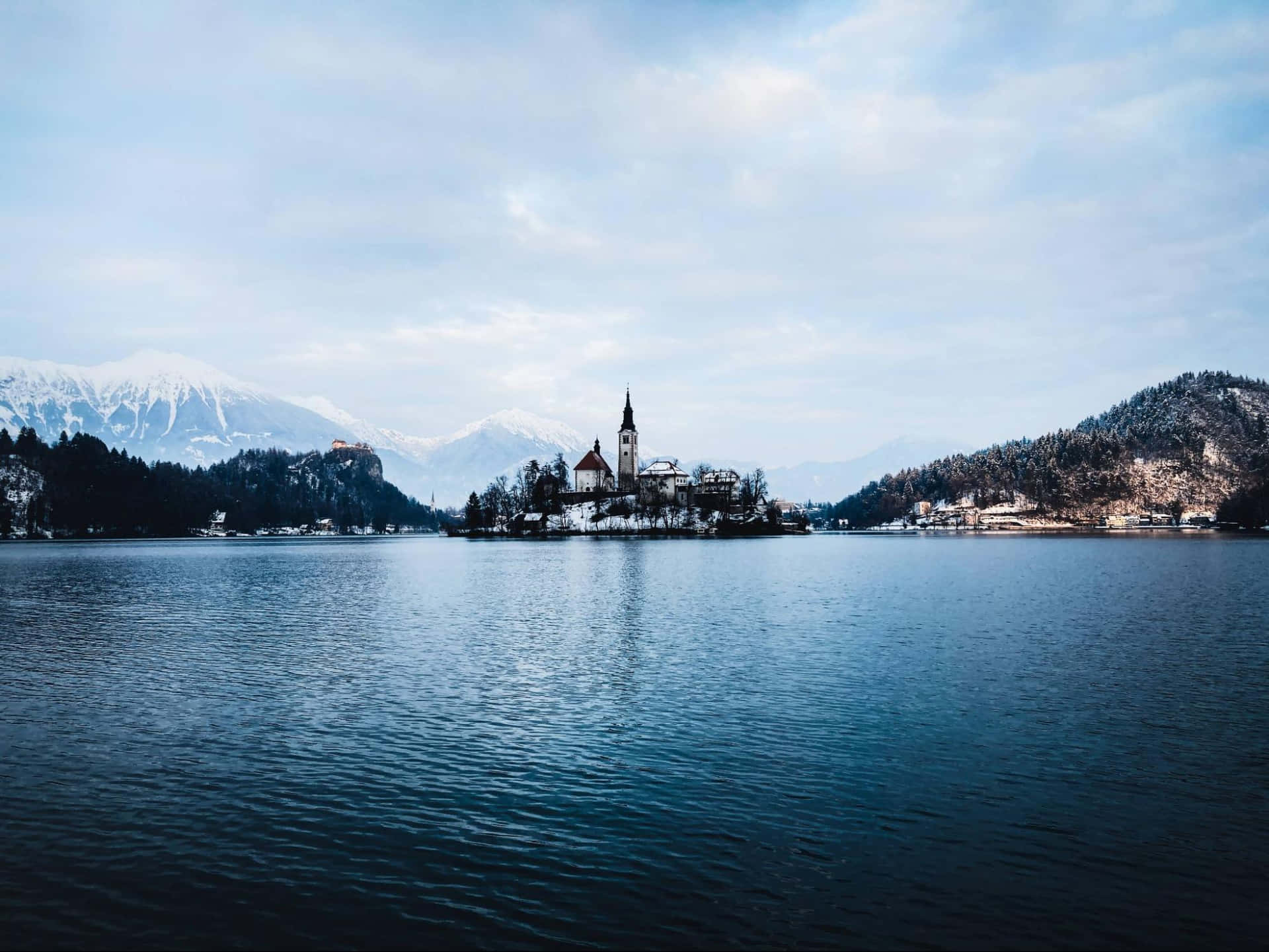 Snow-kissed Julian Alps Encircling Pristine Lake Bled
