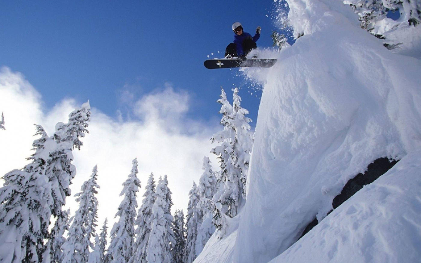 Snowboard Coming Down From High Ledge Background