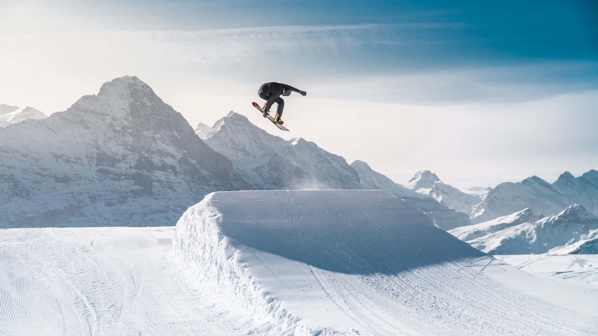 Snowboarder_ Midair_ Mountain_ Backdrop_4 K Background