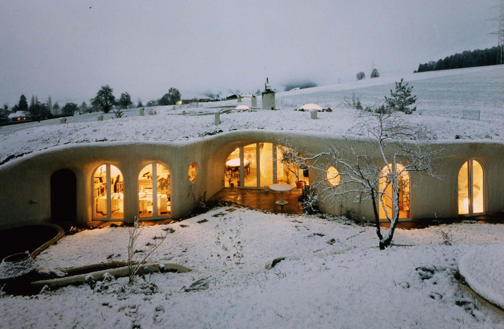 Snowy Earth Sheltered Homeat Dusk Background