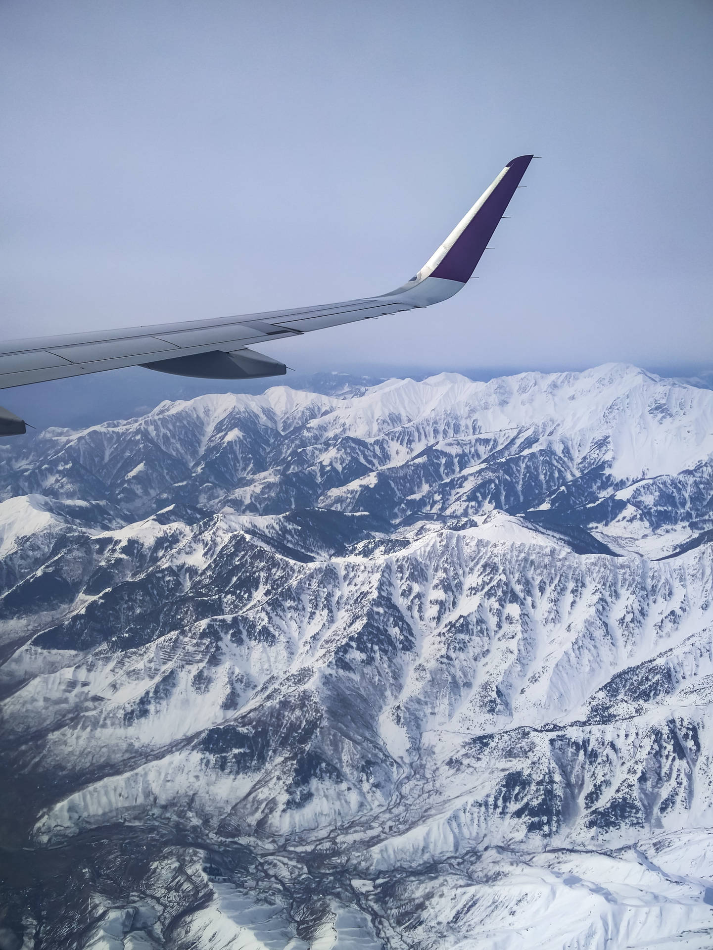 Snowy Mountains Scenery From A Plane Window Background