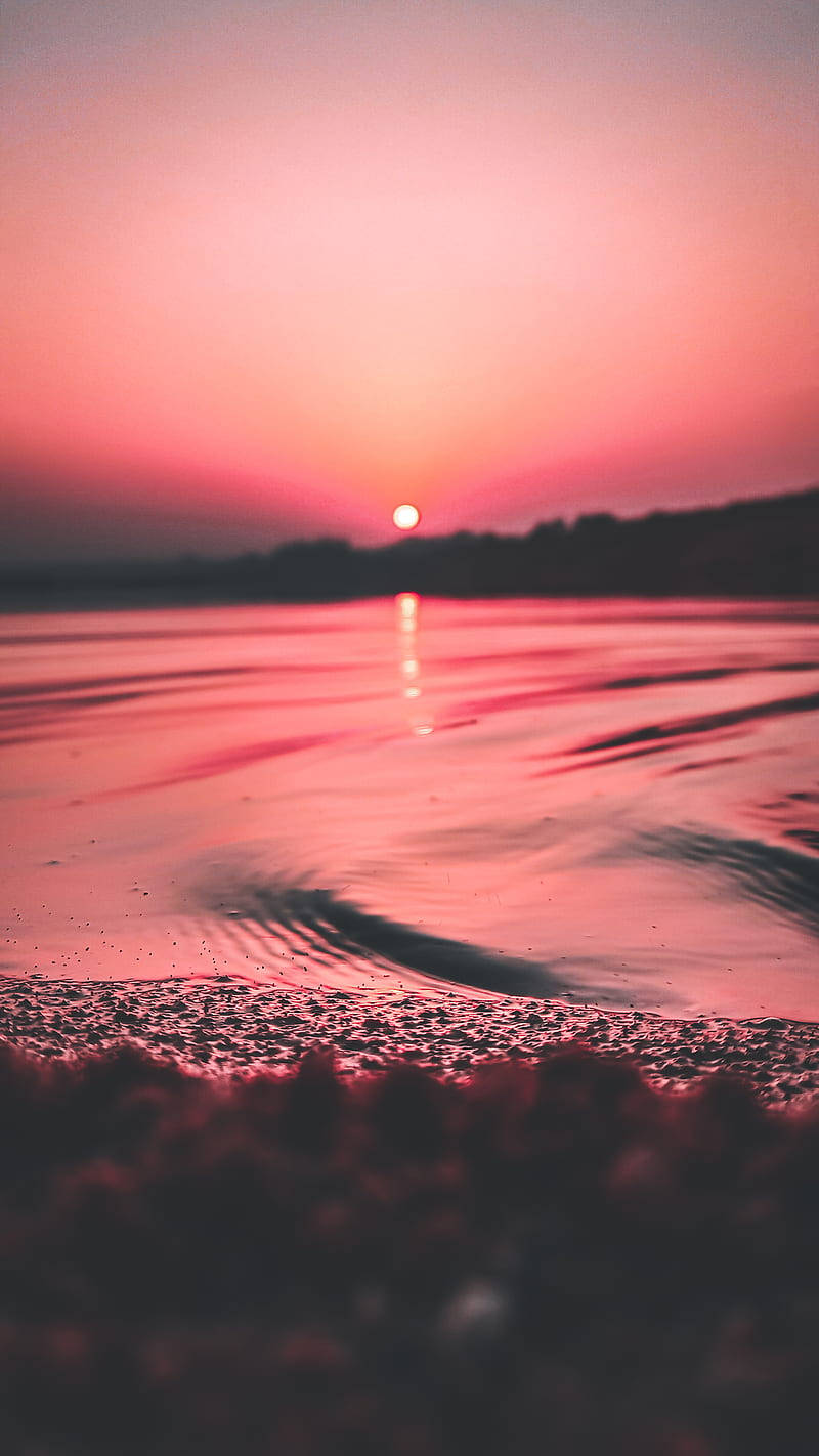 Soak In The Beauty Of A Pink And Orange Sunset With Your Iphone Background