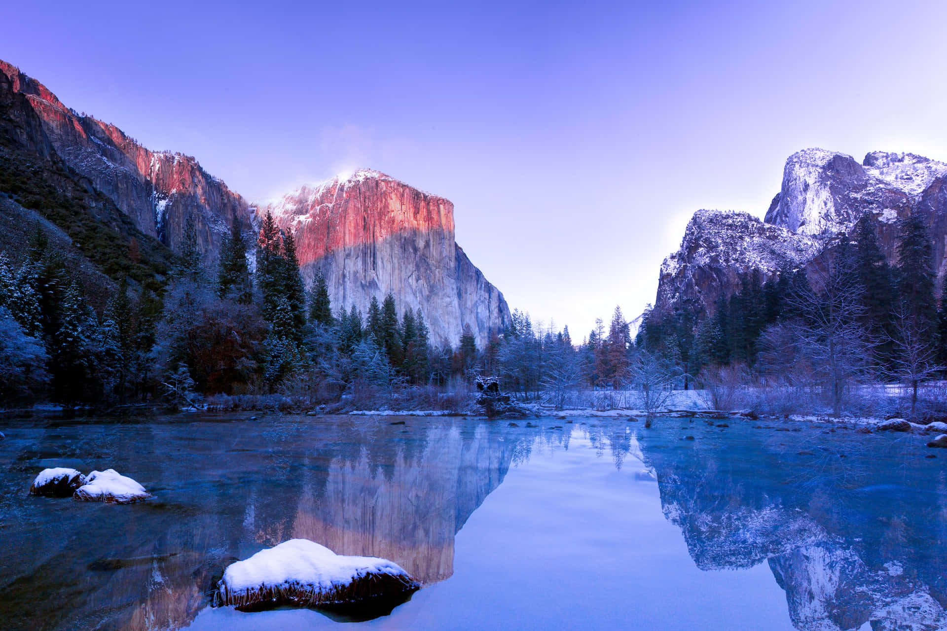 Soak In The Peaceful Beauty Of A Snow-capped Mountain Lake.