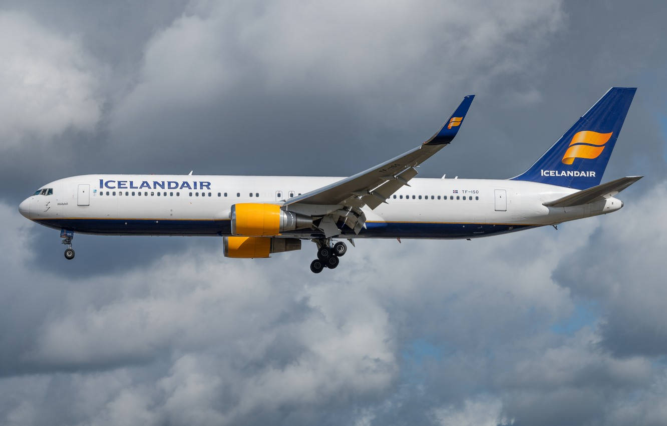 Soaring Icelandair Airplane Under The Dark Clouds