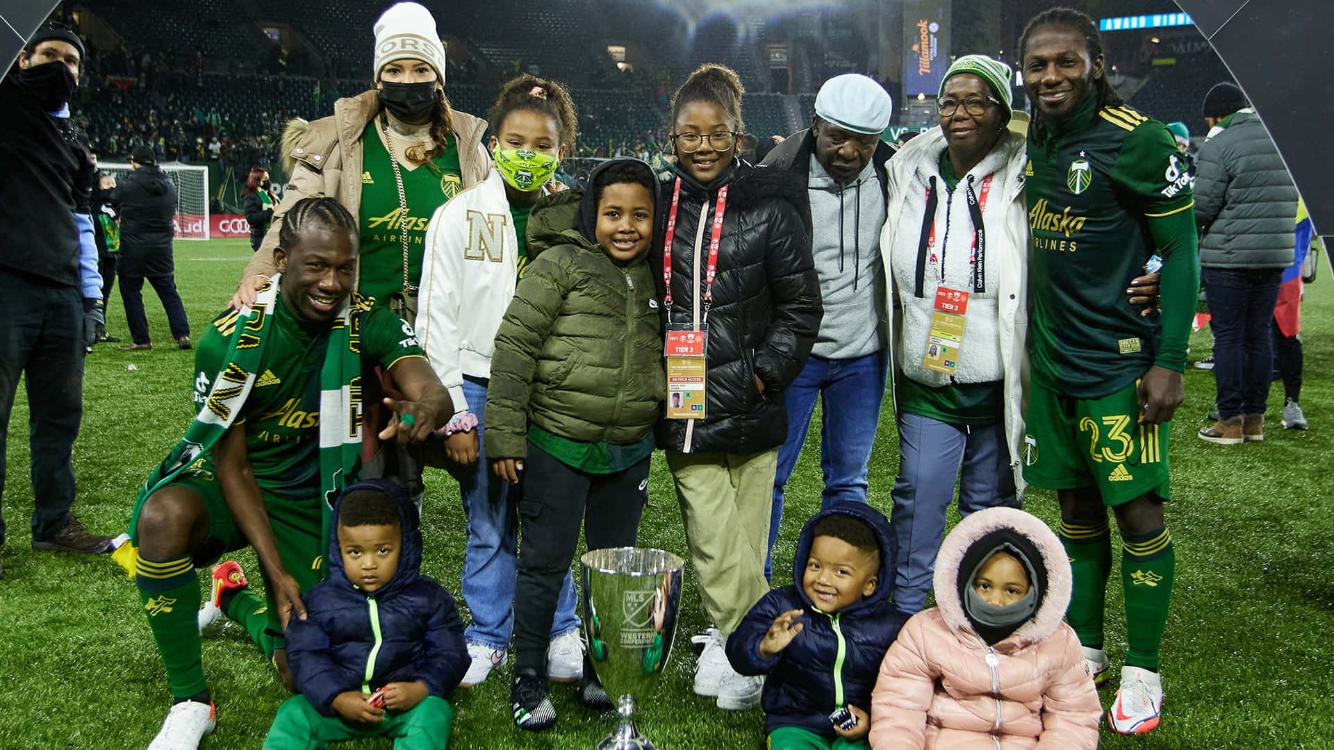 Soccer Champions Celebrationwith Familyand Trophy Background