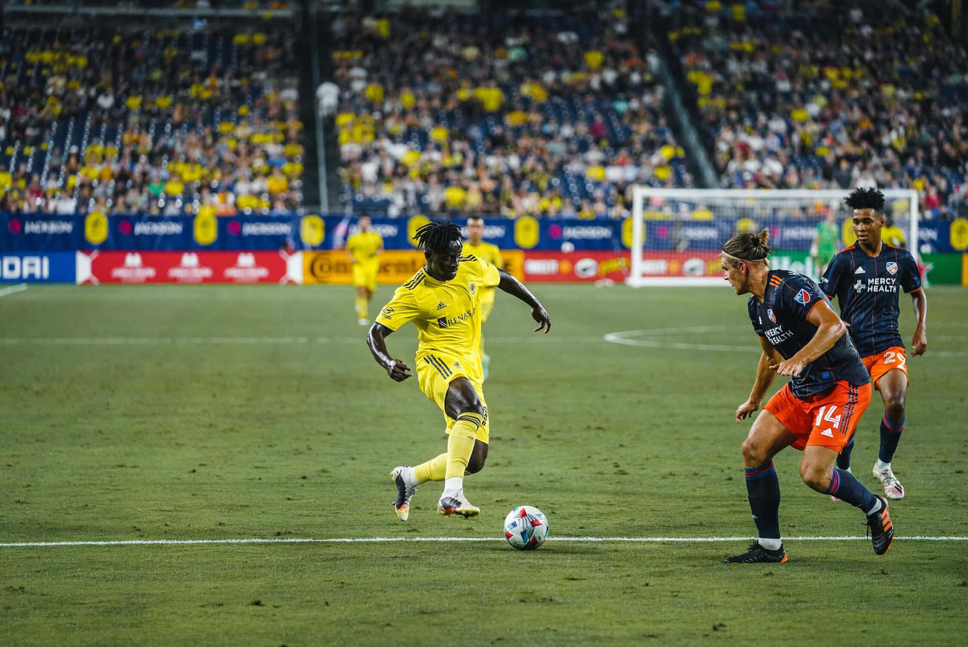 Soccer Match Action Yellowvs Orange Background