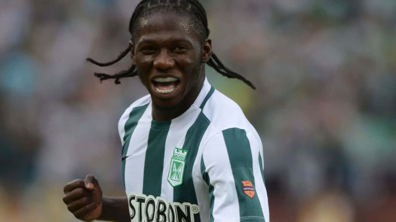 Soccer Player Celebrating On Field Background