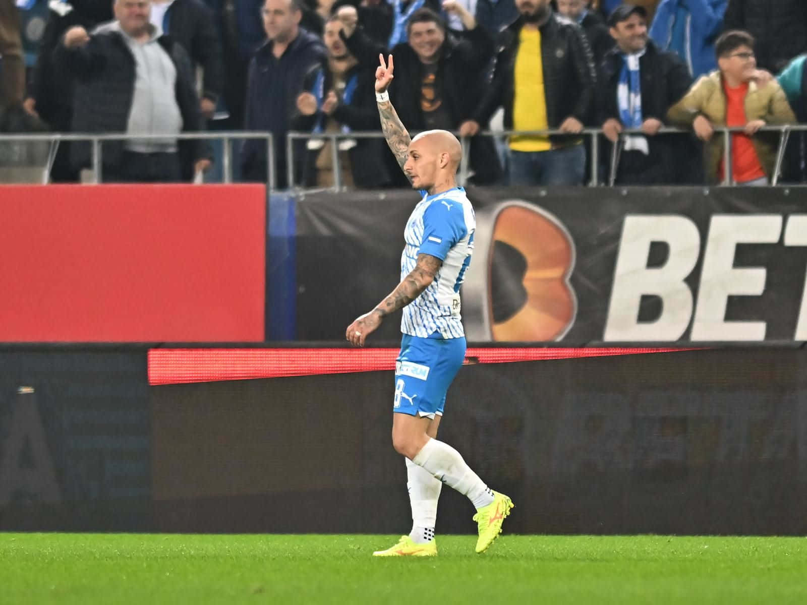 Soccer Player Celebratingon Field Background