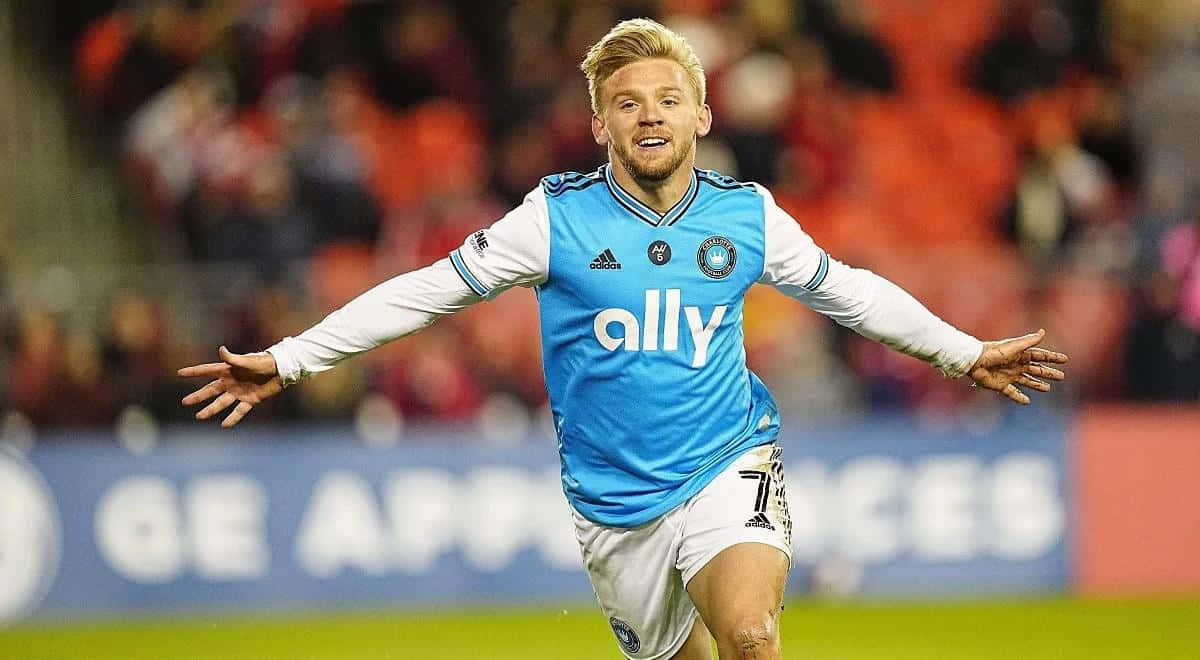 Soccer Player Celebratingon Field Background