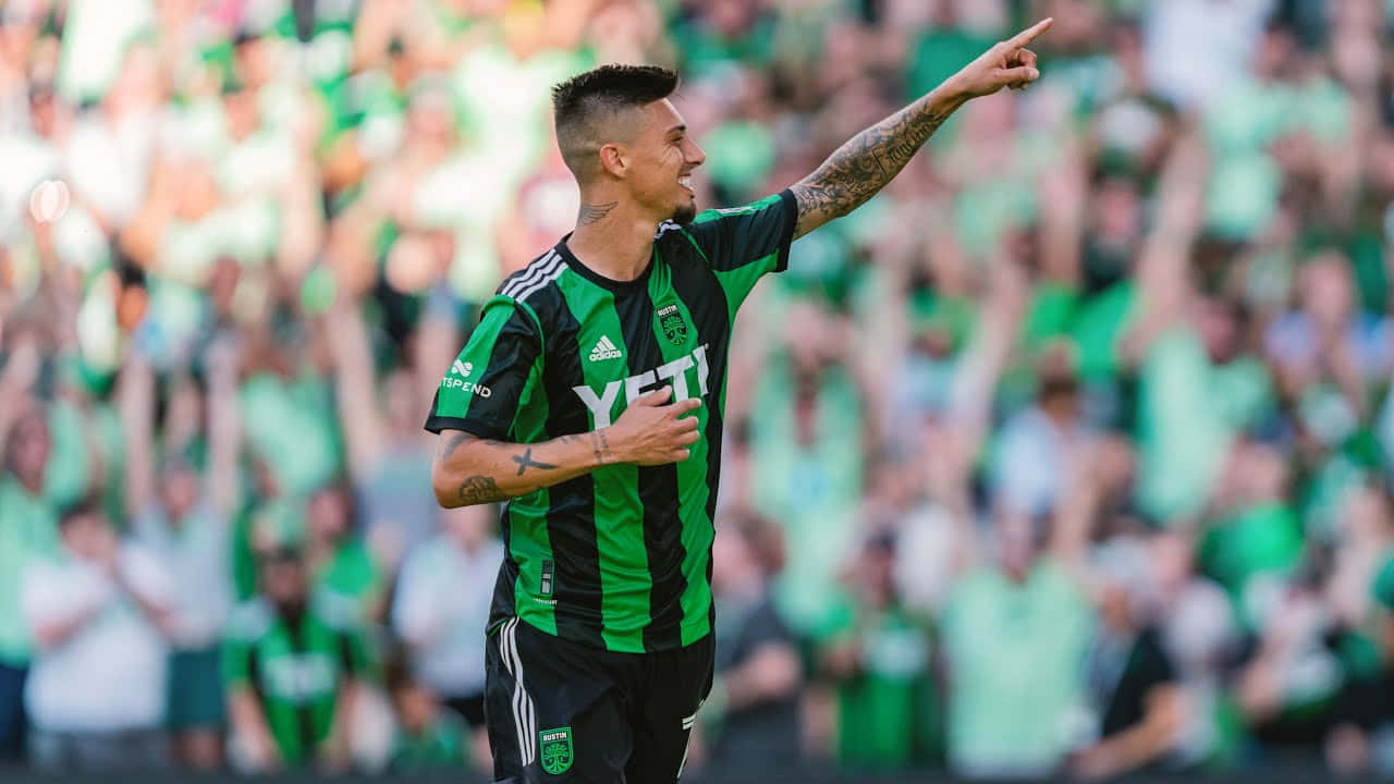 Soccer Player Celebratingon Field Background