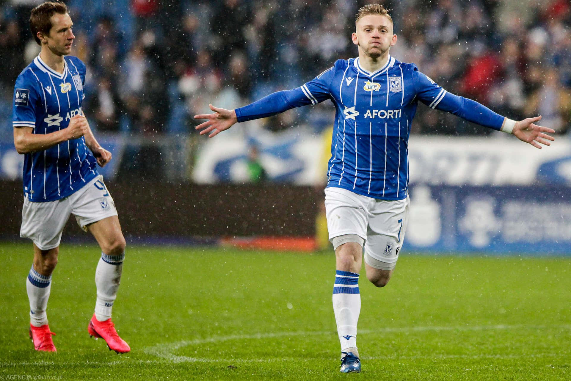Soccer_ Player_ Celebration_in_ Rain Background