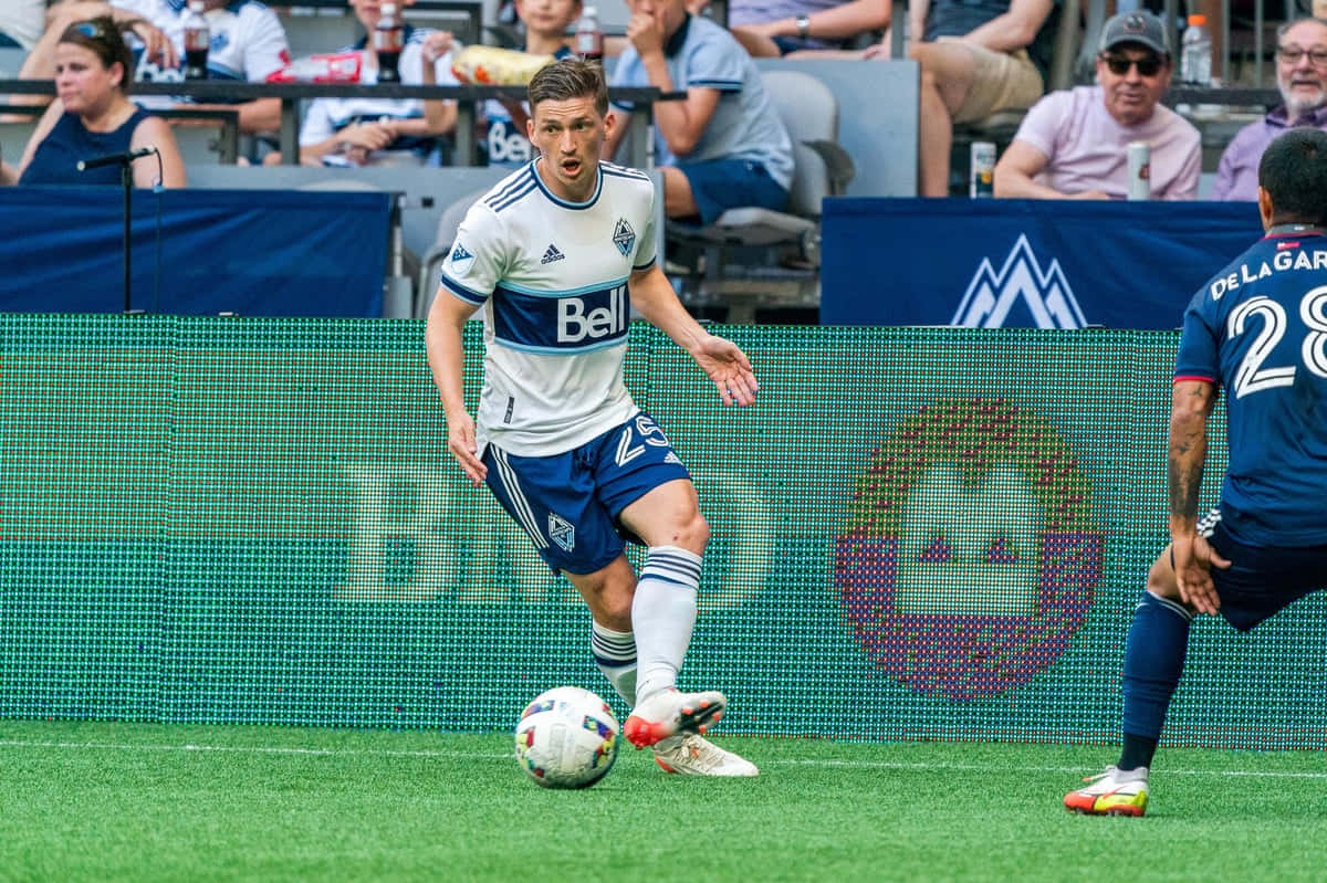 Soccer Player Control Ball During Match Background