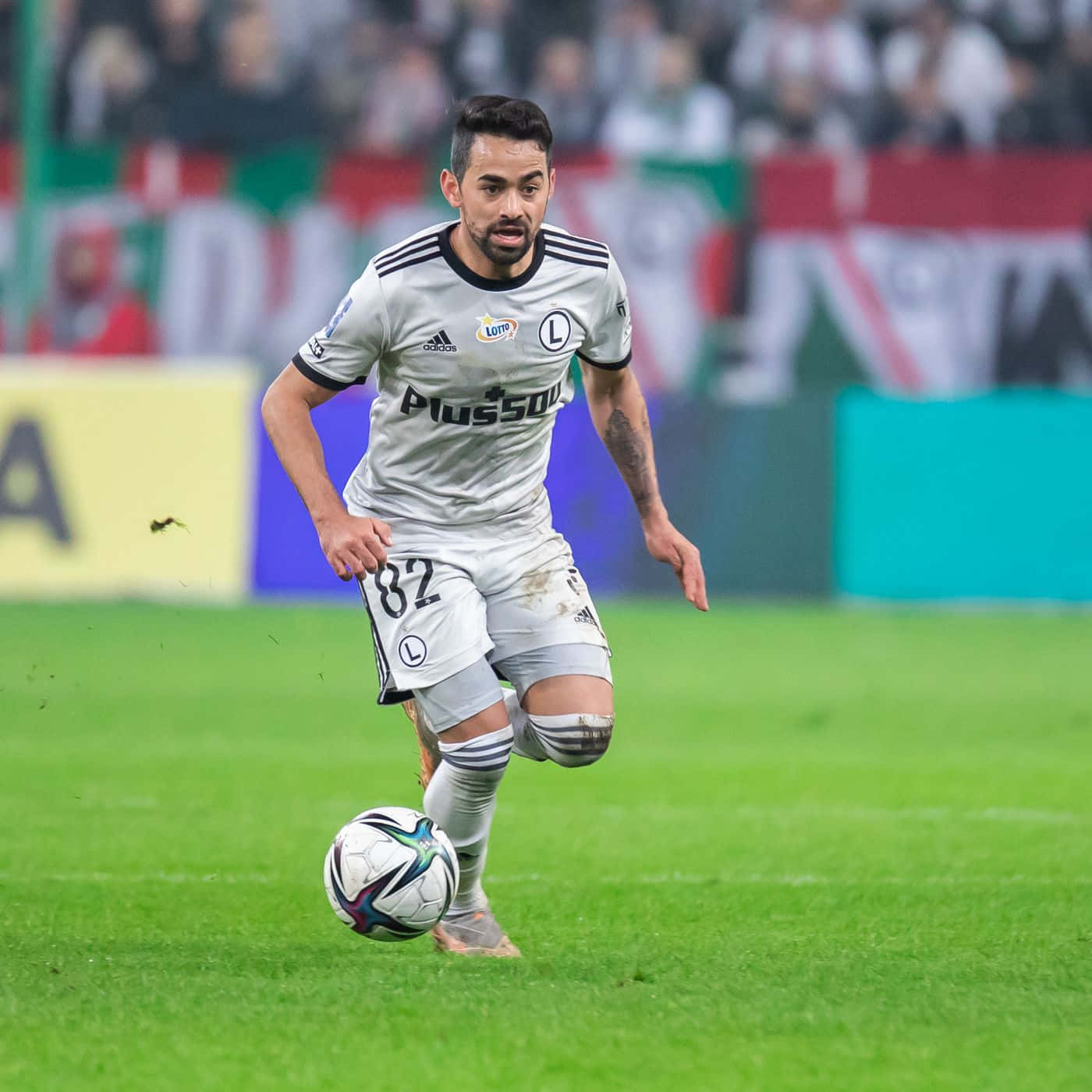 Soccer Player Controling Ball During Match Background