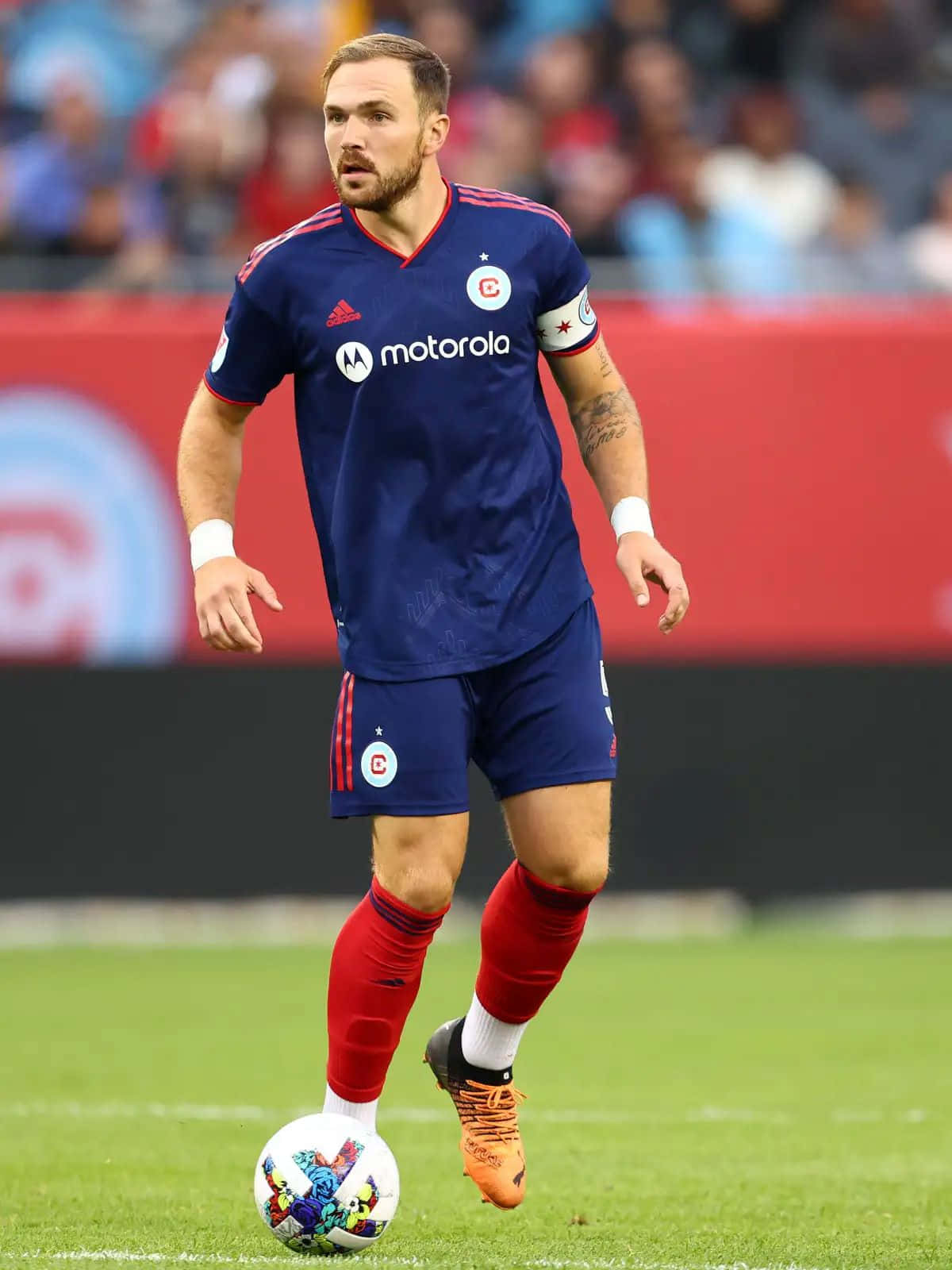 Soccer Player Controling Ball During Match Background