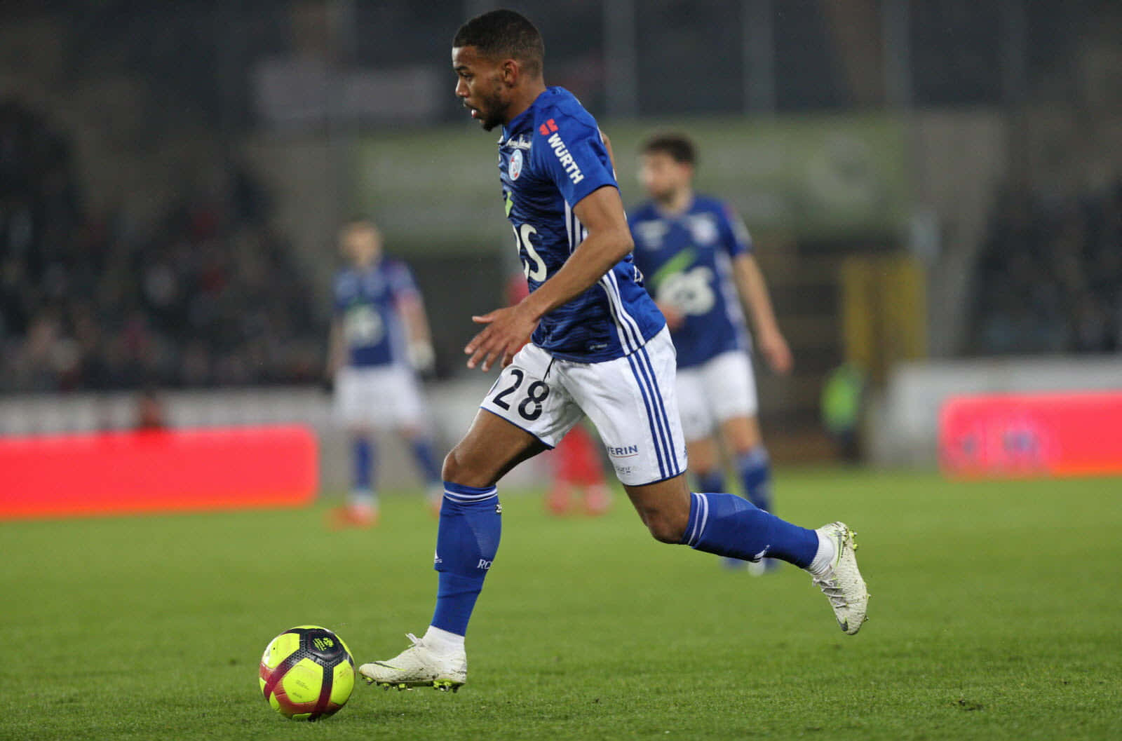 Soccer Player Controling Ball During Match Background