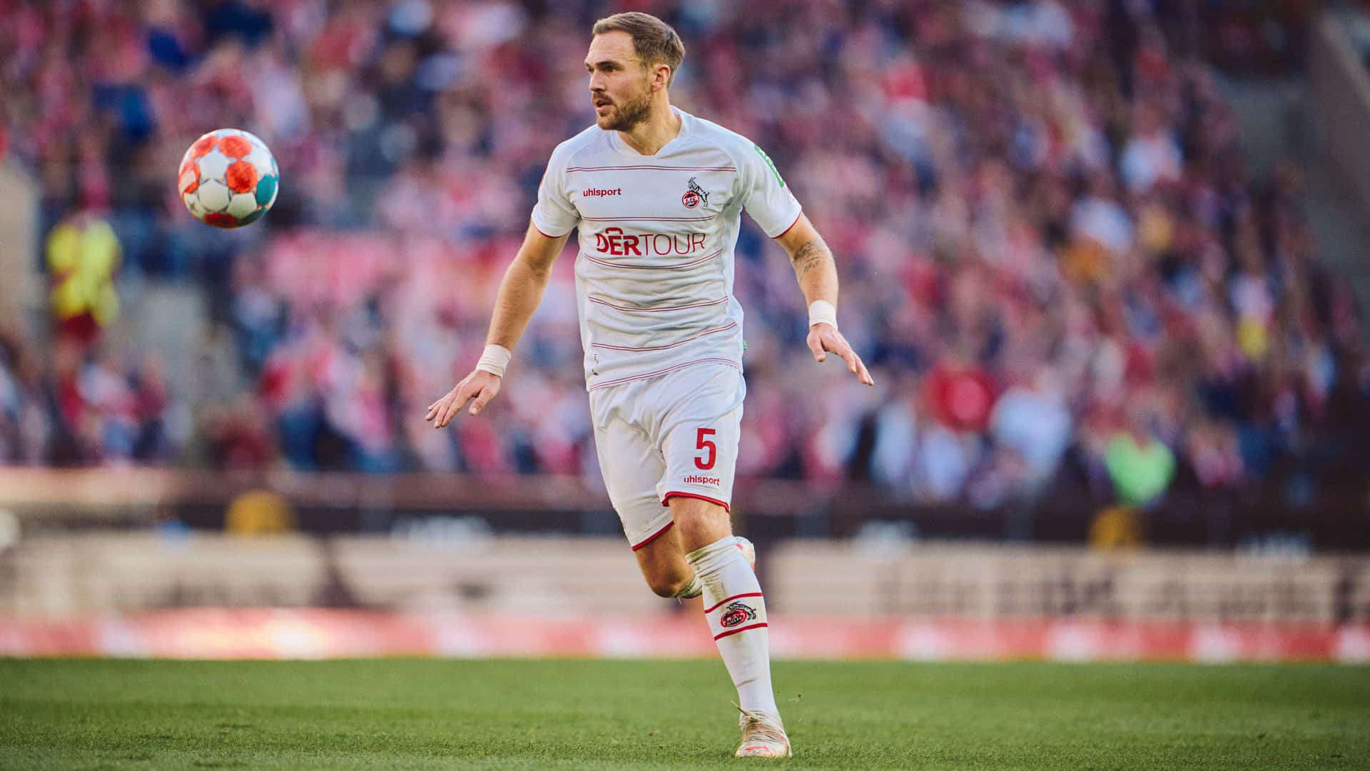 Soccer Player Controling Ball During Match Background