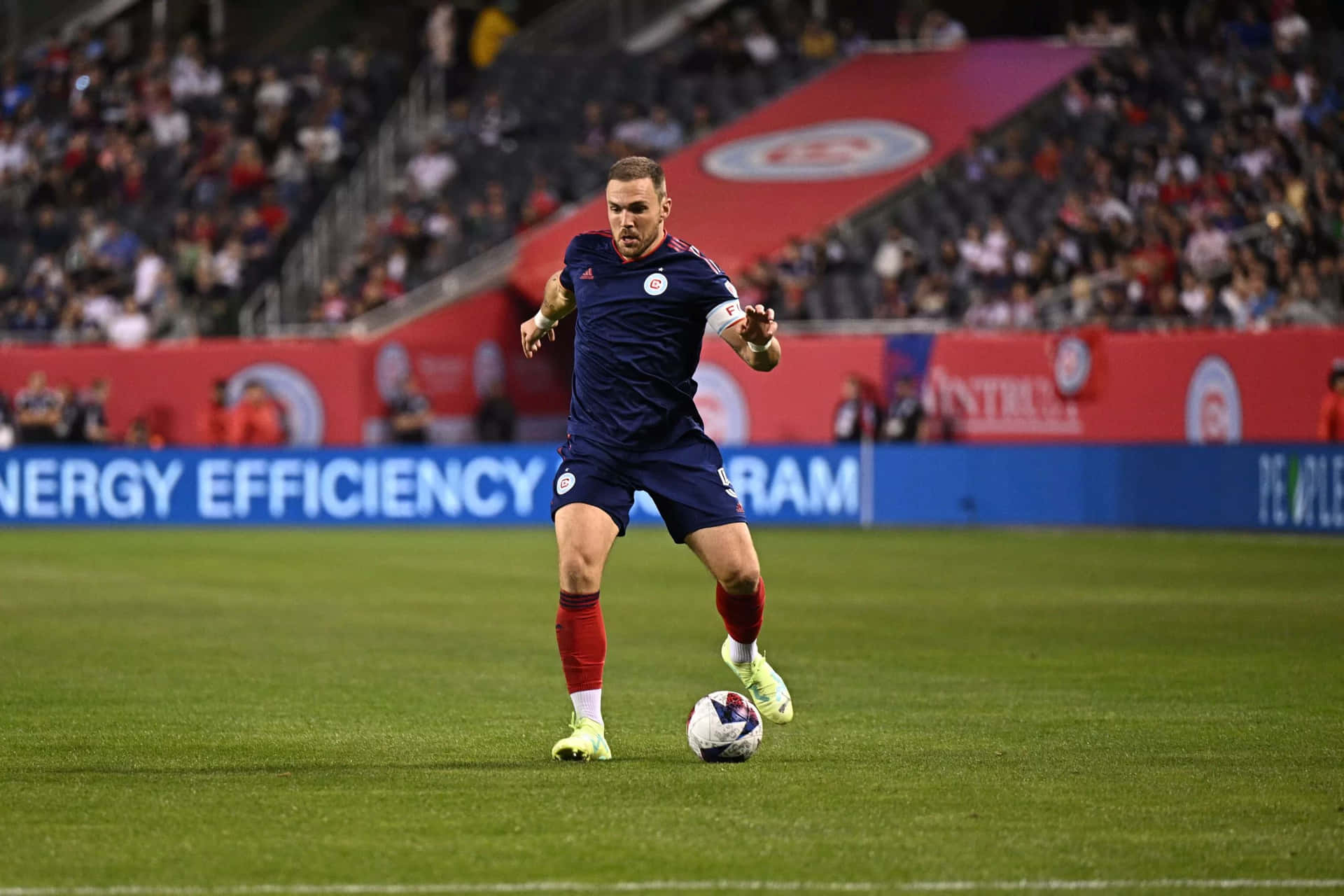 Soccer Player Controling Ballon Field Background