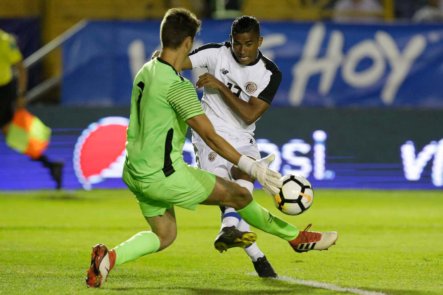 Soccer Player Dribbling Past Goalkeeper Background