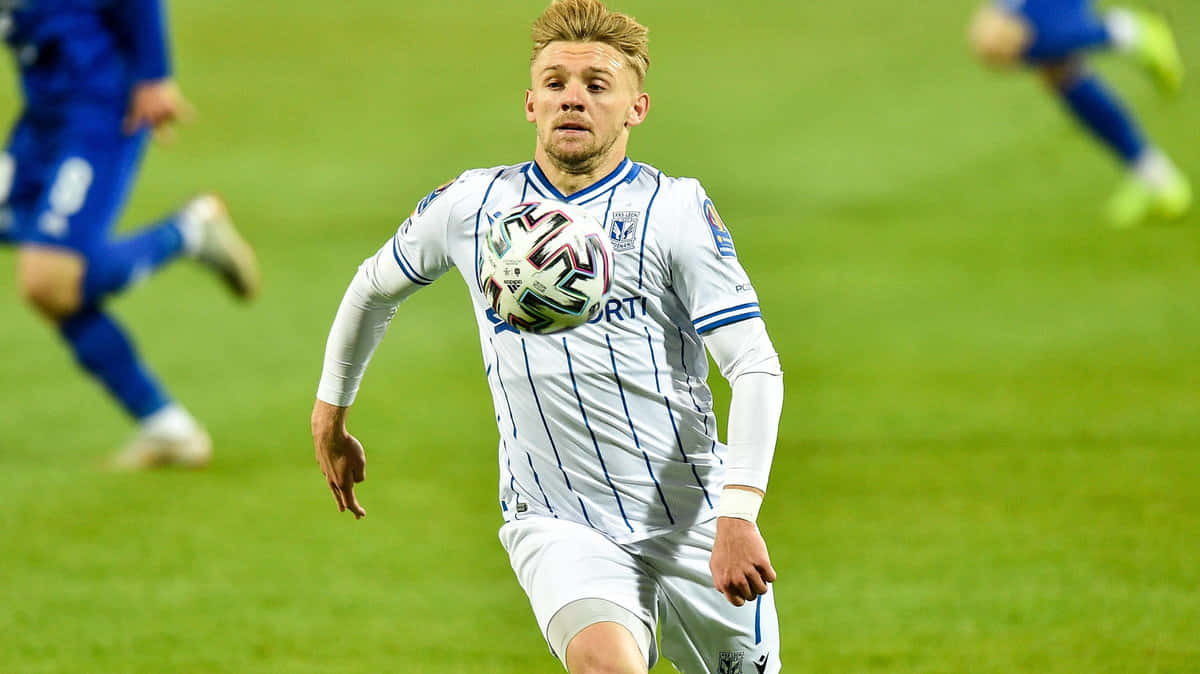 Soccer_ Player_in_ Action_ During_ Match.jpg Background
