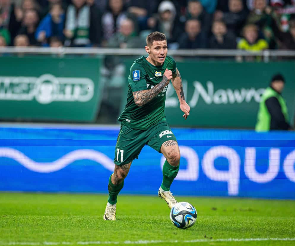 Soccer Player In Action Green Kit Background