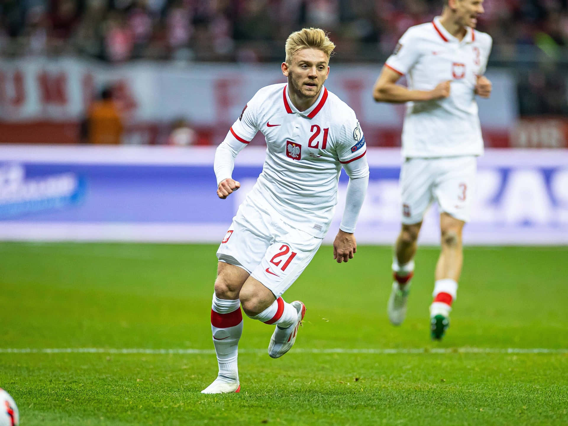Soccer_ Player_in_ Action_on_ Field Background