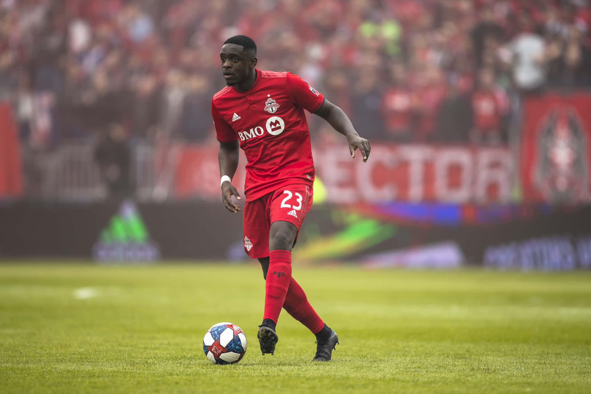 Soccer_ Player_in_ Action_on_ Field Background