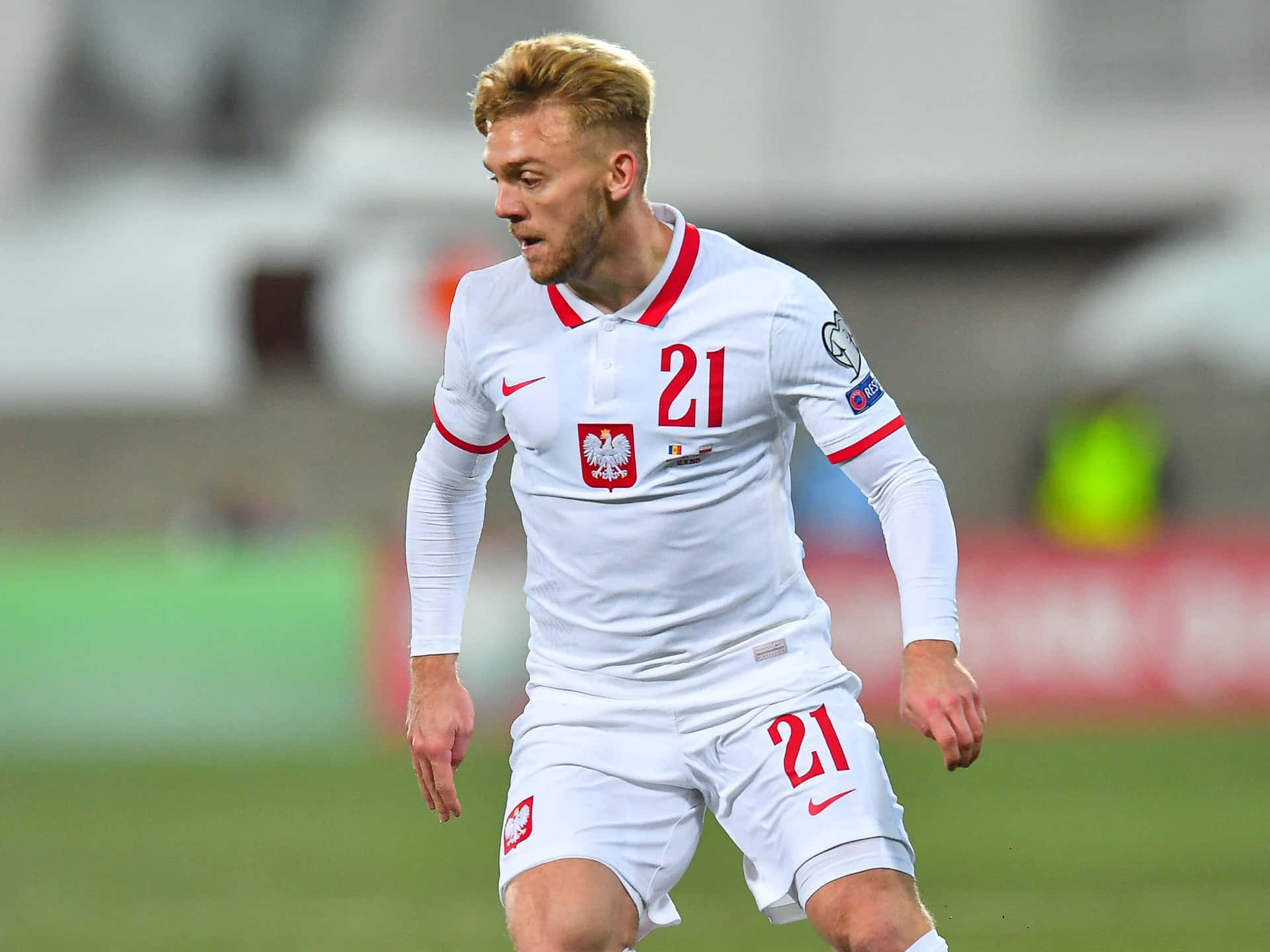 Soccer_ Player_in_ Action_on_ Field Background
