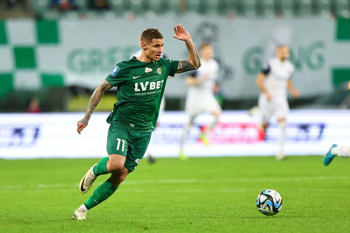 Soccer_ Player_ In_ Action_ On_ Field.jpg Background