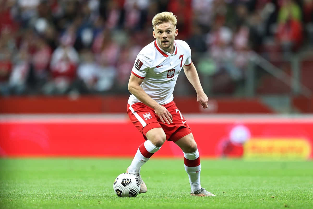 Soccer_ Player_in_ Action_on_ Field Background