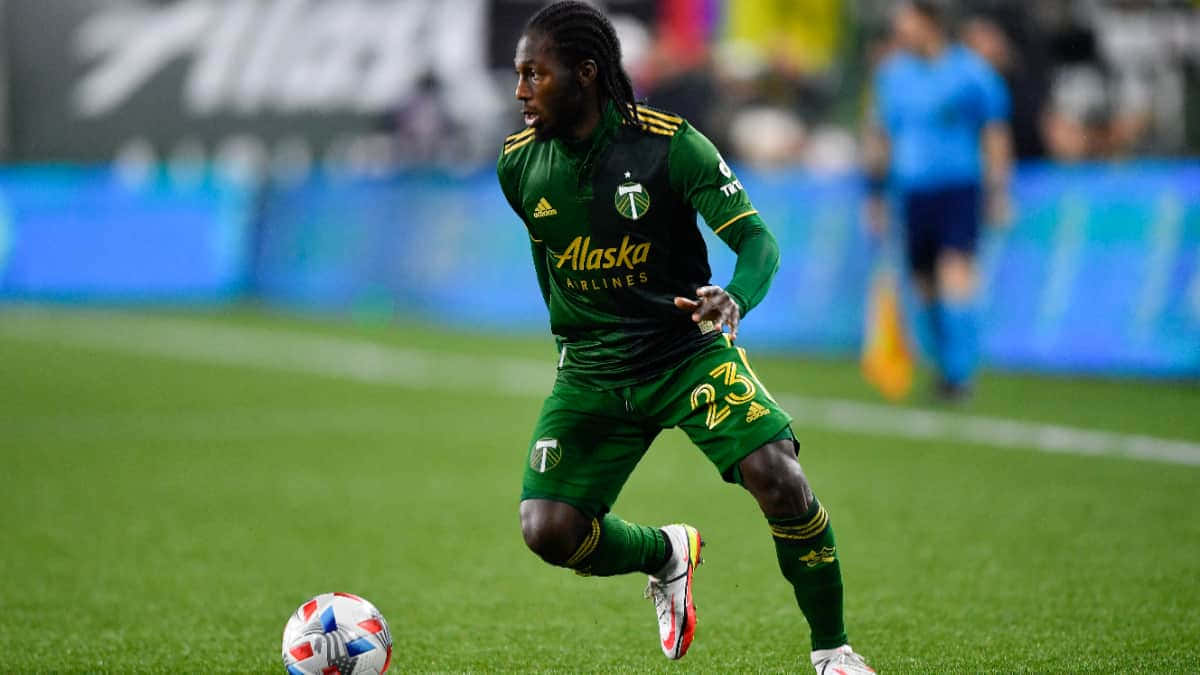 Soccer_ Player_in_ Action_on_ Field Background