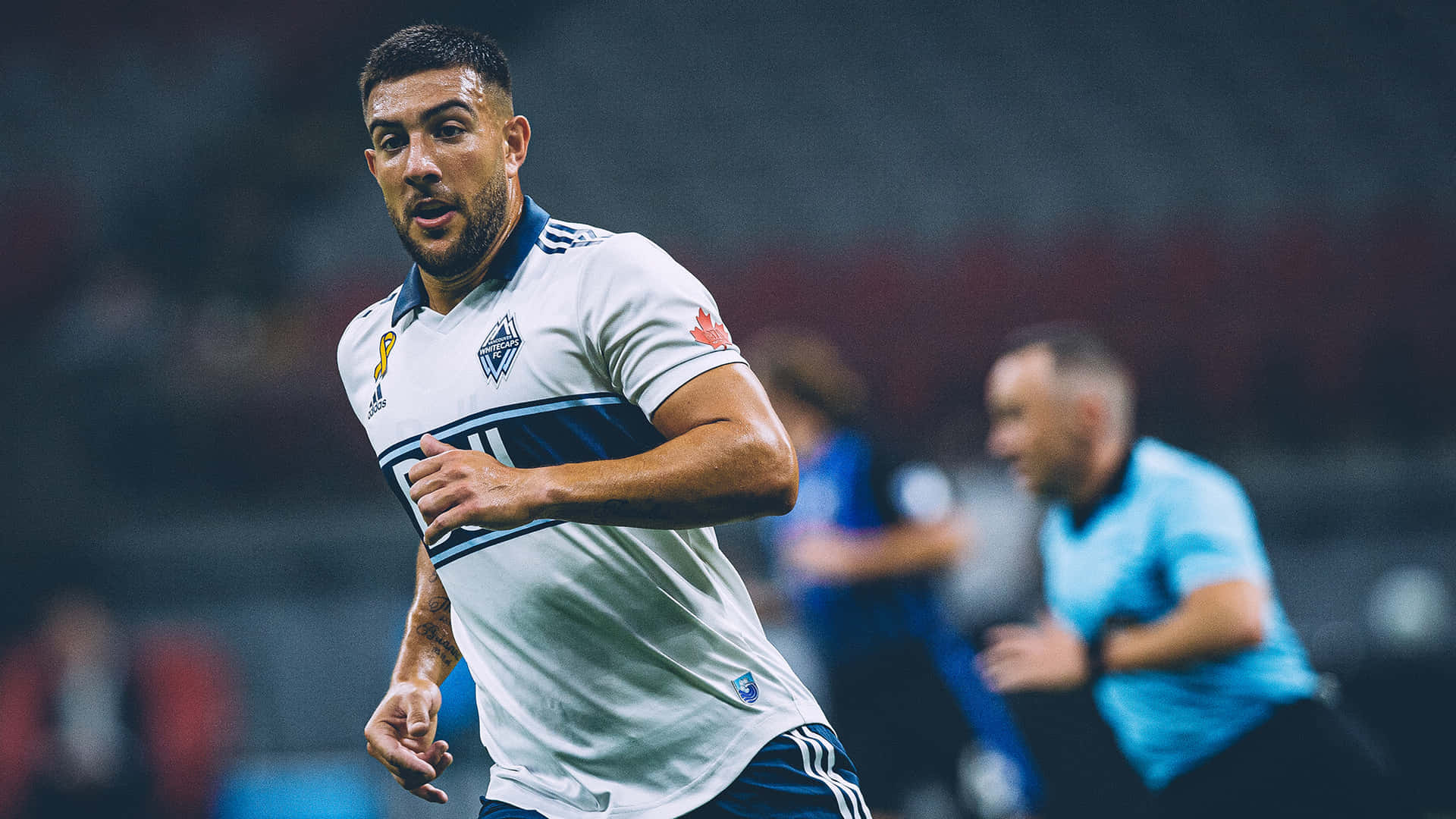 Soccer_ Player_ In_ Action_ On_ Field Background